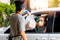 Worker Wearing PPE Delivering Food Safely to Masked Women